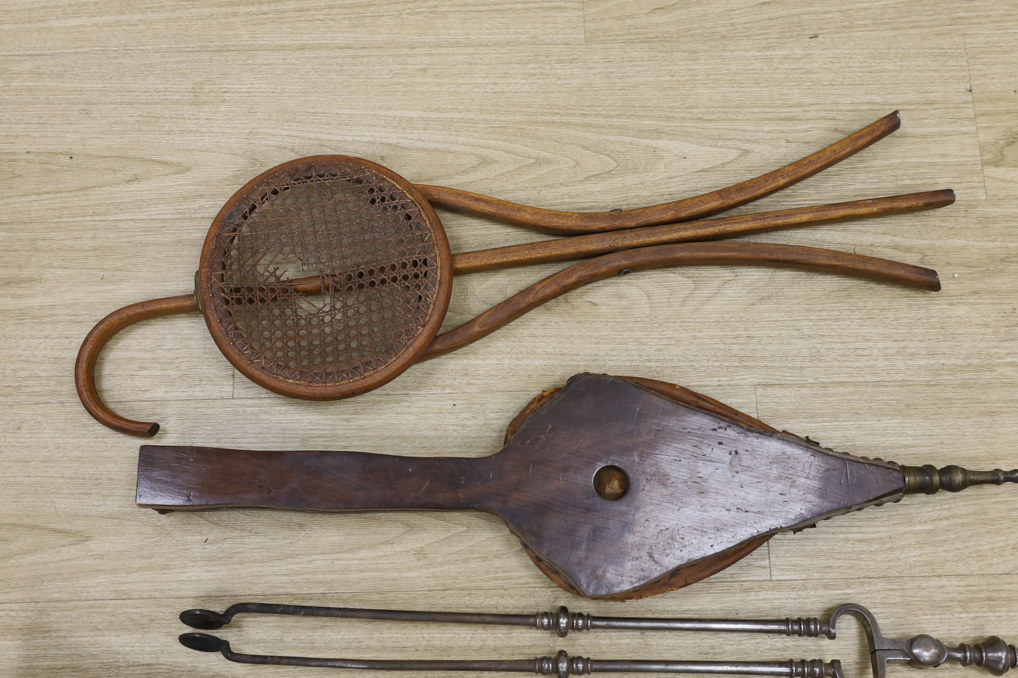 A set of three late Georgian steel fire irons, 79cm in length, together with a bellows and folding seat